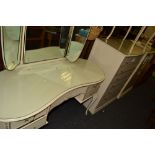 A mid 20th century white and mahogany lined kidney shaped dressing table;