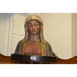 A 20th century painted terracotta bust of the Virgin Mary, on an ebonised plinth,