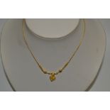 A Thailand gold coloured metal necklace, heart pendant, 7.