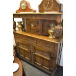 An Old Charm type oak buffet, carved with S-scrolls and flutes,