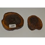 A carved treen circular plaque, depicting Christ in relief;  another, larger,