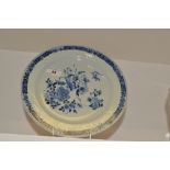 A Chinese circular plate, decorated in underglaze blue with foliage and flowers,
