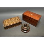 A red marble circular inkwell;  a rectangular rosewood tea caddy with mother of pearl inlay;