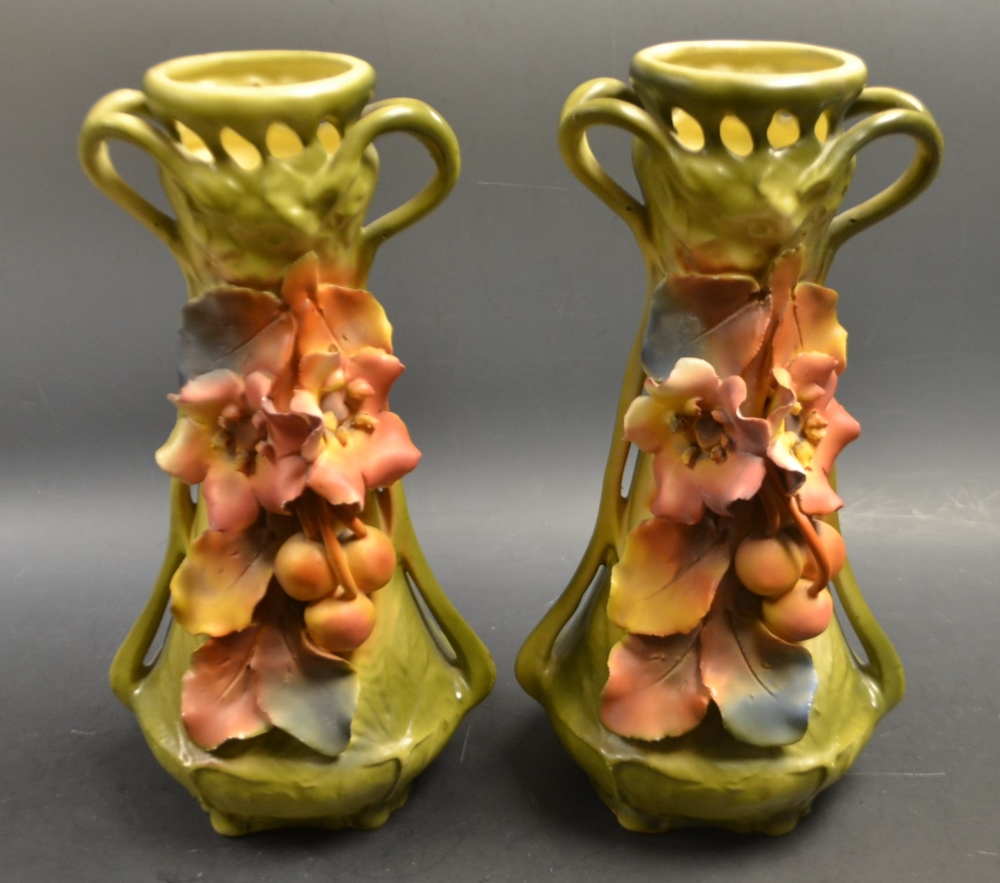 A pair of Royal Dux Austrian twin handled vases, pierced necks,