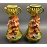 A pair of Royal Dux Austrian twin handled vases, pierced necks,