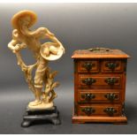 A resin figure of a Chinaman, mounted on a rectangular base;  a miniature Chinese cabinet,