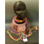 A tribal Kenyan bead and shell necklace;  another,