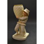 A Royal Worcester figure, boy carrying a basket,