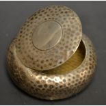 An Arts and Crafts hammered circular snuff box, hinged cover, gilt interior, Henry Matthews,