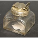 A silver topped inkwell,