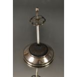 A silver hat pin stand,