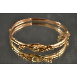 A late Victorian seed pearl and 9ct rose gold hinge bangle, 5.