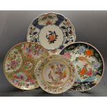 An Oriental plate; another, decorated with birds and butterflies; another,