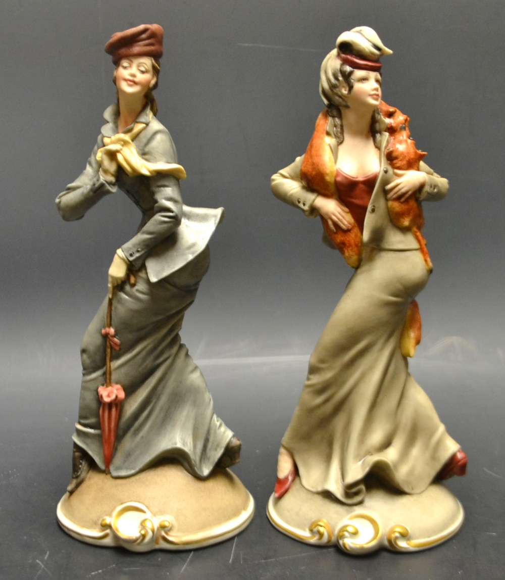 A pair of Capodimonte porcelain painted figures, Girls with Fox Fur Stole, windswept,