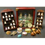 A curiosity glass front display cabinet containing miniatures including  Beswick rabbits ,