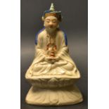 A Chinese porcelain figure, of Buddha, seated on a lotus,
