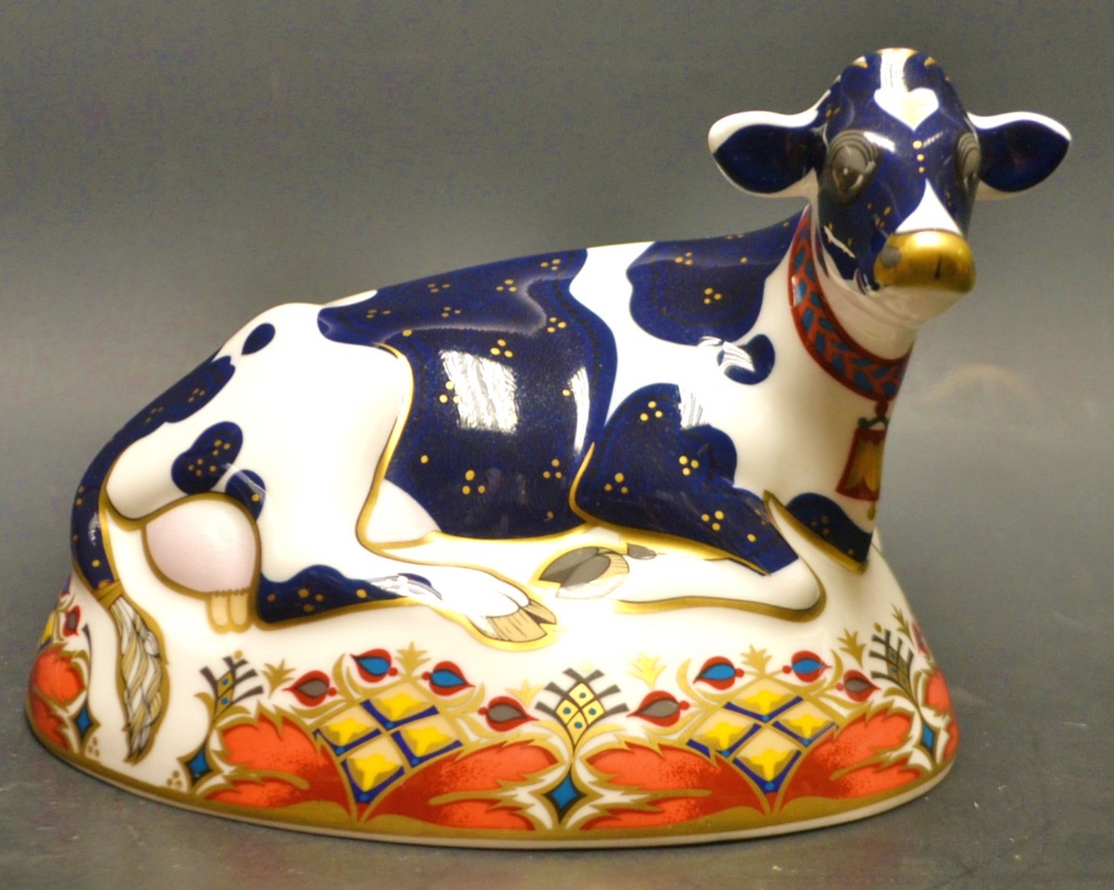 A Royal Crown Derby paperweight, Frisian Cow Buttercup, printed mark, silver stopper.