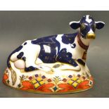 A Royal Crown Derby paperweight, Frisian Cow Buttercup, printed mark, silver stopper.