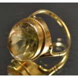 A yellow quartz and 9ct gold dress ring, large faceted oval stone,