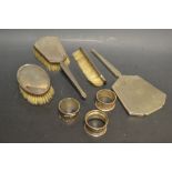 A silver four piece dressing table set;