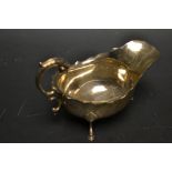 A silver sauce boat, in George III style, flying acanthus scroll handle, wavy rim, Birmingham 1922,