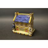 A Staffordshire Pearlware type money box, modelled as a cottage, with arched windows,