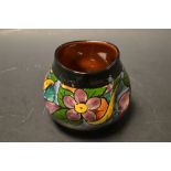 A Watcombe pottery dimpled circular vase, printed with flowers,