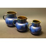 A set of three Denby Danesby Ware graduated ovoid jugs, glazed in Electric Blue, ribbed necks,