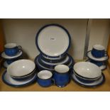 A Denby pottery table service, comprising four dinner plates, four bowls, four cups and saucers,