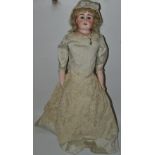 An early 20th century bisque head doll, with sleeping blue eyes, open mouth, four teeth,