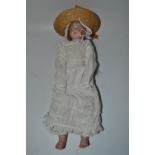 A French bisque head and shoulder doll, weighted blue eyes, open mouth showing upper teeth,