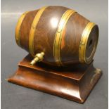 Treen - a 19th century brass bound lignum vitae barrel, mounted on a spreading rectangular plinth,