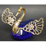 A large blue glass and silver swan