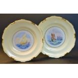 A pair of Royal Crown Derby shaped circular plates, painted  by W.E.