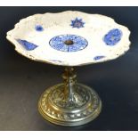 A Victorian cake stand, the EPNS pedestal embossed with scrolls, Chinoiserie Staffordshire plate,
