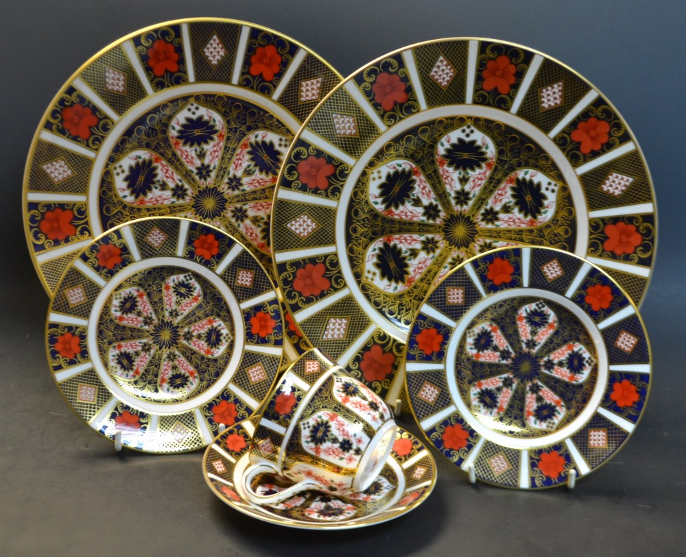 Royal Crown Derby - a pair of 1128 Imari dinner plates; a pair of side plates; a cup and saucer,