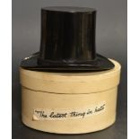 A novelty Saville plastic top hat with a miniature perfume bottle inside,