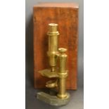 A 19th century brass microscope, adjustable barrel, iron U-shaped base, 24cm high,