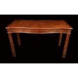 A late 18th century mahogany serving table, moulded top, serpentine front, deep frieze,