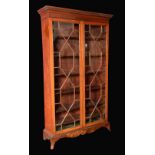 An Edwardian mahogany bookcase, stepped cornice, fretworked frieze,