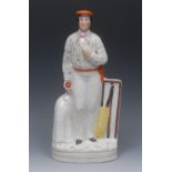 A Victorian Staffordshire figure of a cricketer, modelled as a bowler with jacket, wicket and bat,