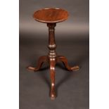 A George III mahogany kettle stand, circular dished top, arrow decoration to the border,