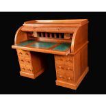 A Victorian light oak cylinder desk, three quarter gallery,