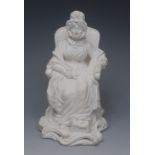 A Derby biscuit figure, of an elderly lady seated on a chair, one foot on a stool, scroll base,