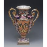 A Derby two-handled pedestal urnular vase, decorated in he Imari palette,