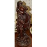 A Chinese hardwood figural lamp base, of a deity, standing,