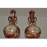 A pair of Oriental vases, rouge ground,
