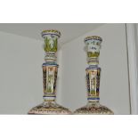 A pair of Rouen faience candlesticks, typically coloured in blue,