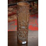 A Chinese bamboo bitong brush pot, carved in relief with figures amongst the canes,