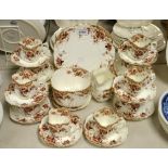 A Staffordshire tea service decorated with summer flowers, comprising cake plate, ten tea plates,